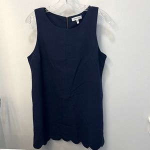 Navy blue classic shift dress with scalloped bottom.